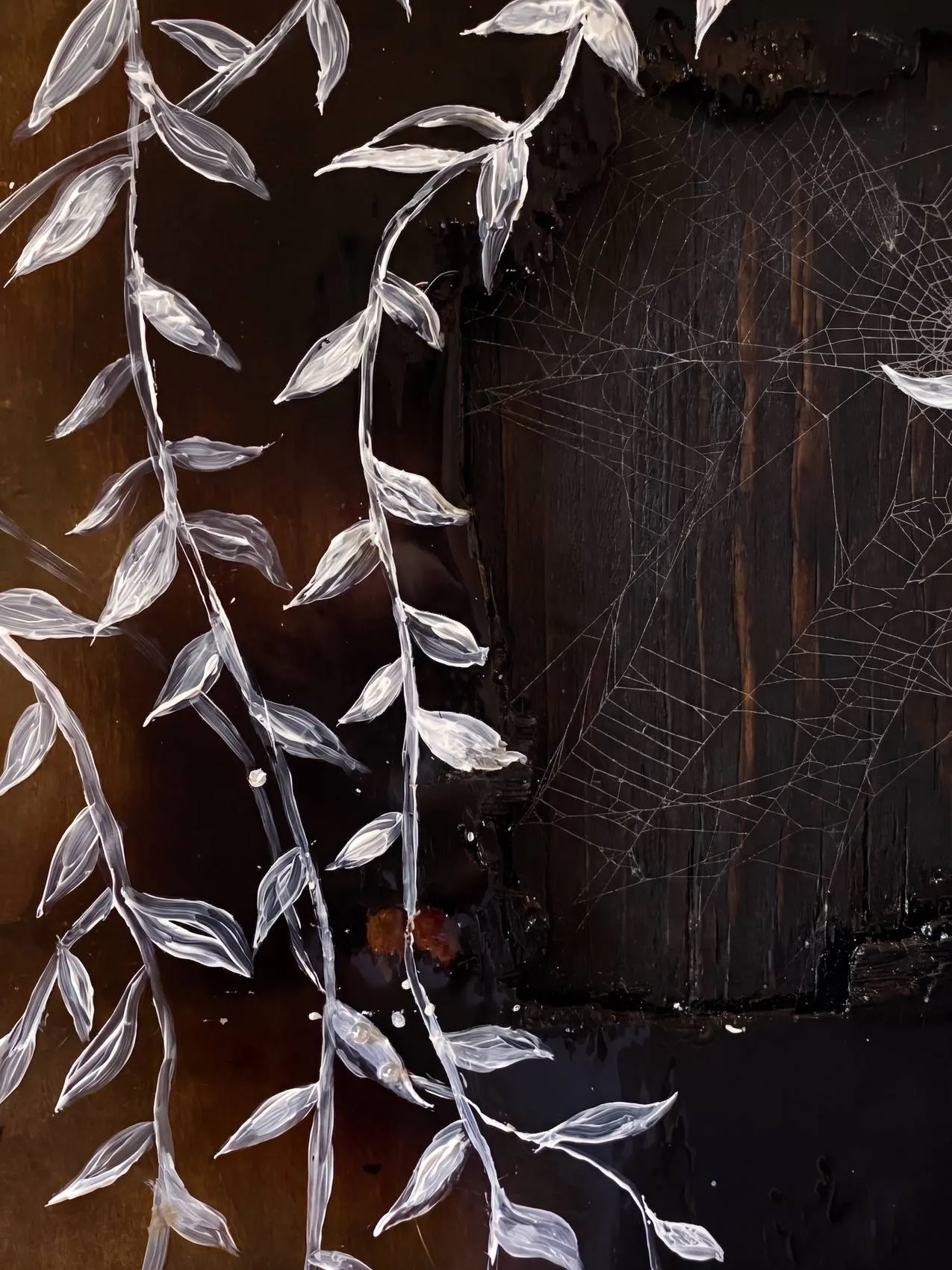 Detail — painted foliage across a preserved web in resin.